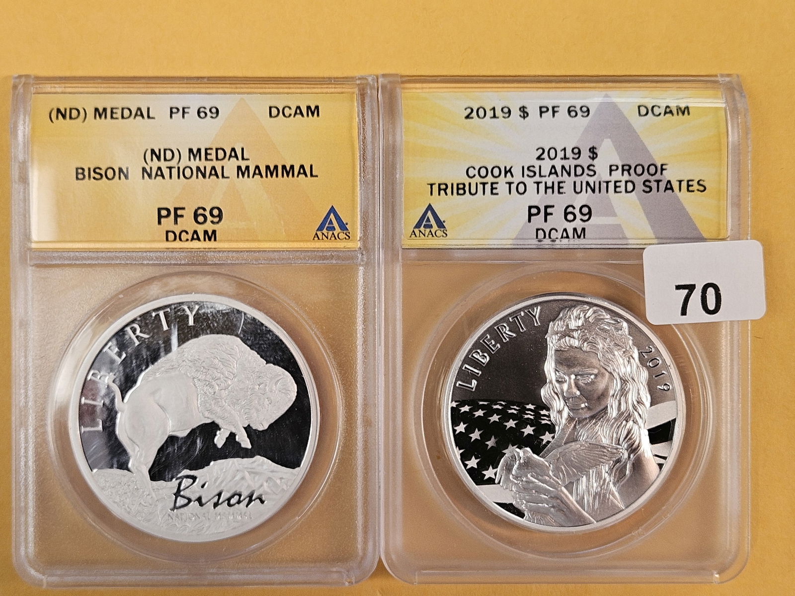 Two Near-Perfect ANACS-graded medal and Coin: Both Proof 69 Deep Cameo. Bison and Cook Islands 