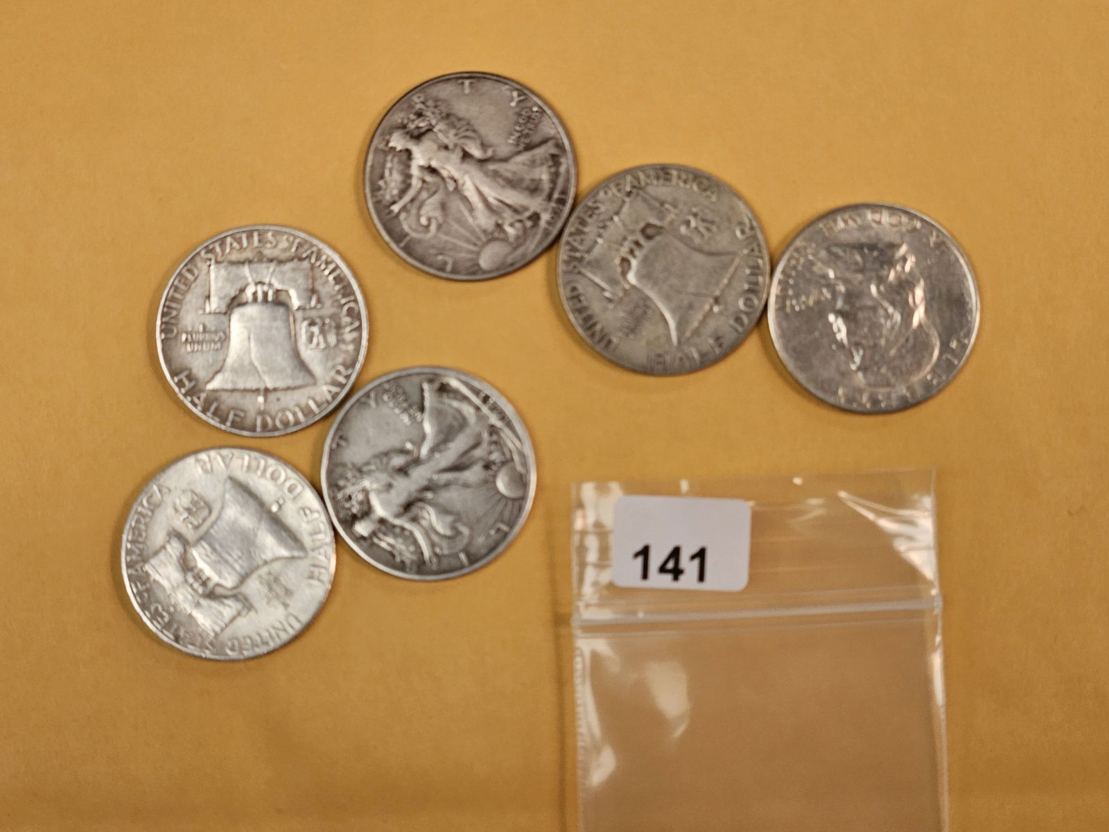 Six mixed silver Half Dollars: Franklins and Walkers