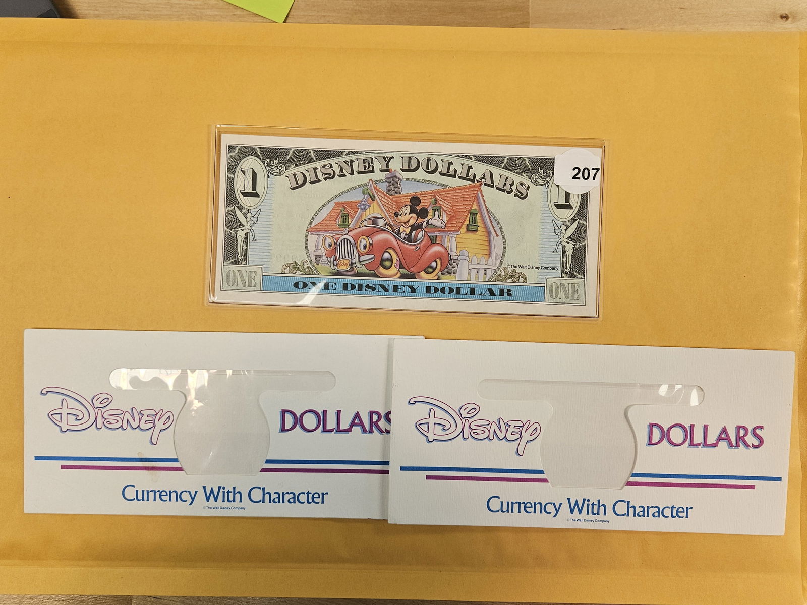DISNEY DOLLAR!: Crisp Uncirculated Mickey's 65th One Dollar and two empty Disney Dollar Envelopes 