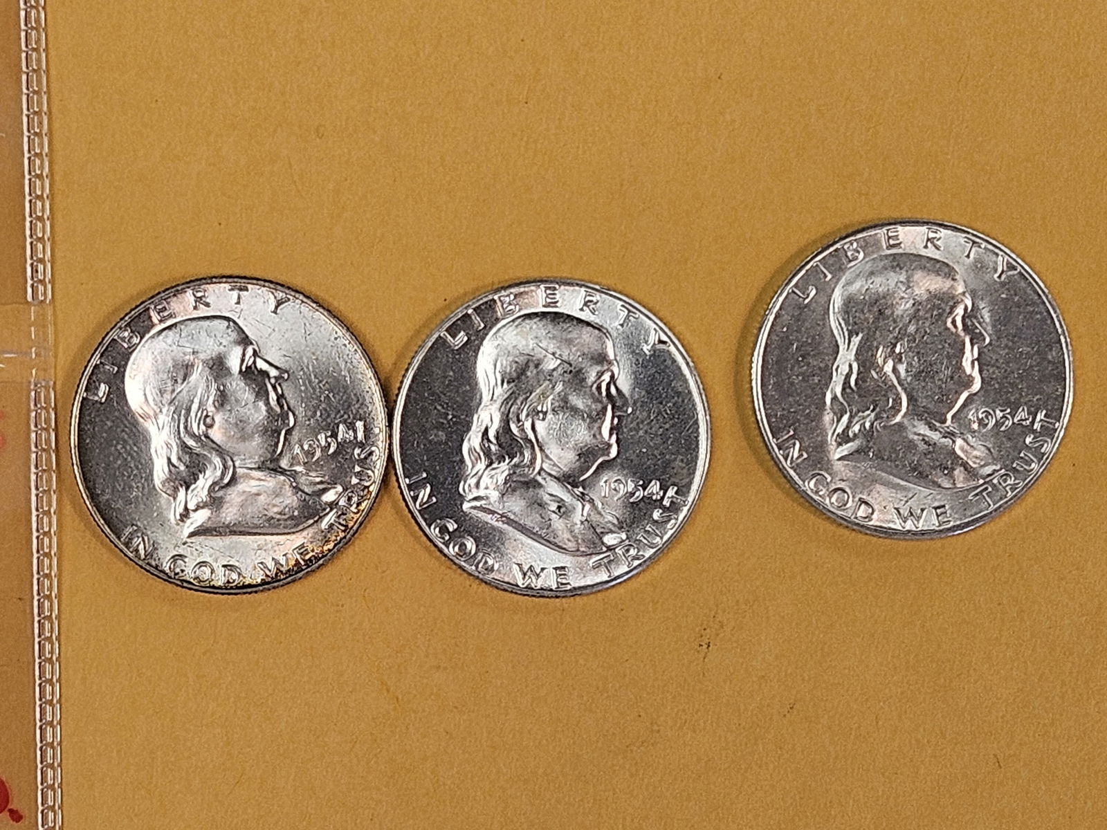 Three Choice to Very Choice Brilliant Uncirculated Franklin silver half dollars: 1954 P-D-S