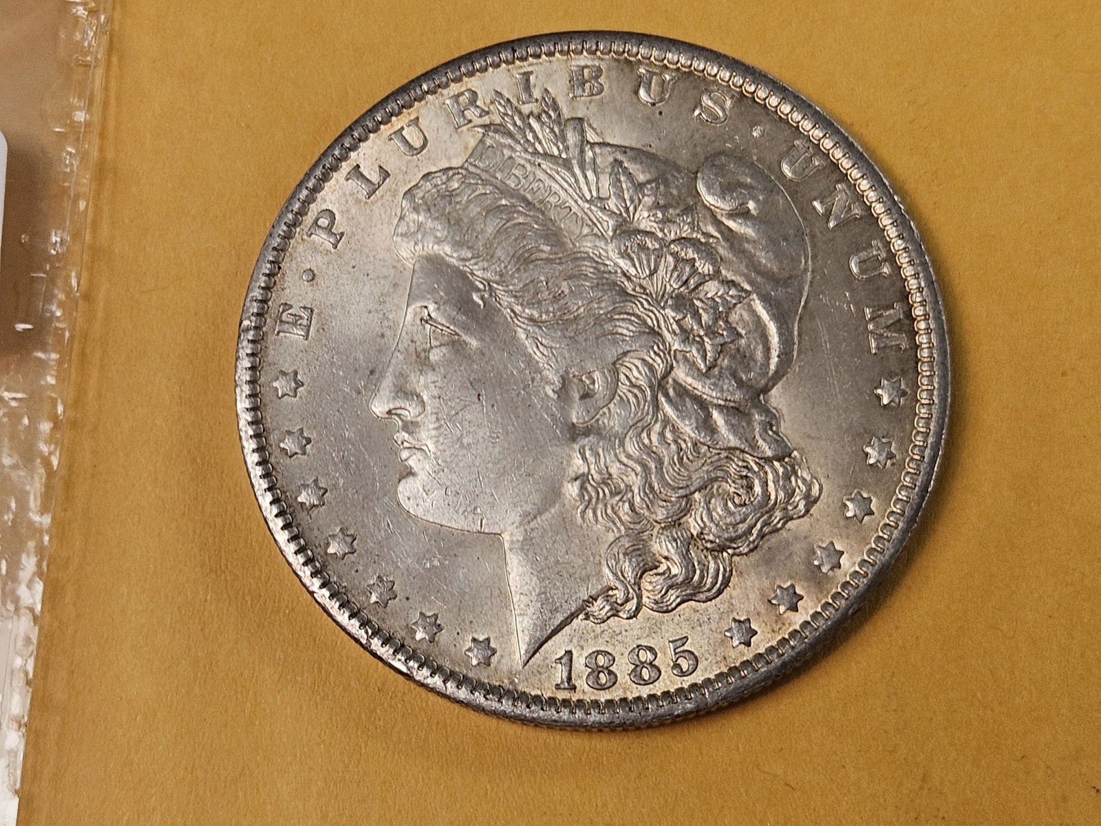 Choice Brilliant About Uncirculated plus 1885-O Morgan Dollar: Lite patina 