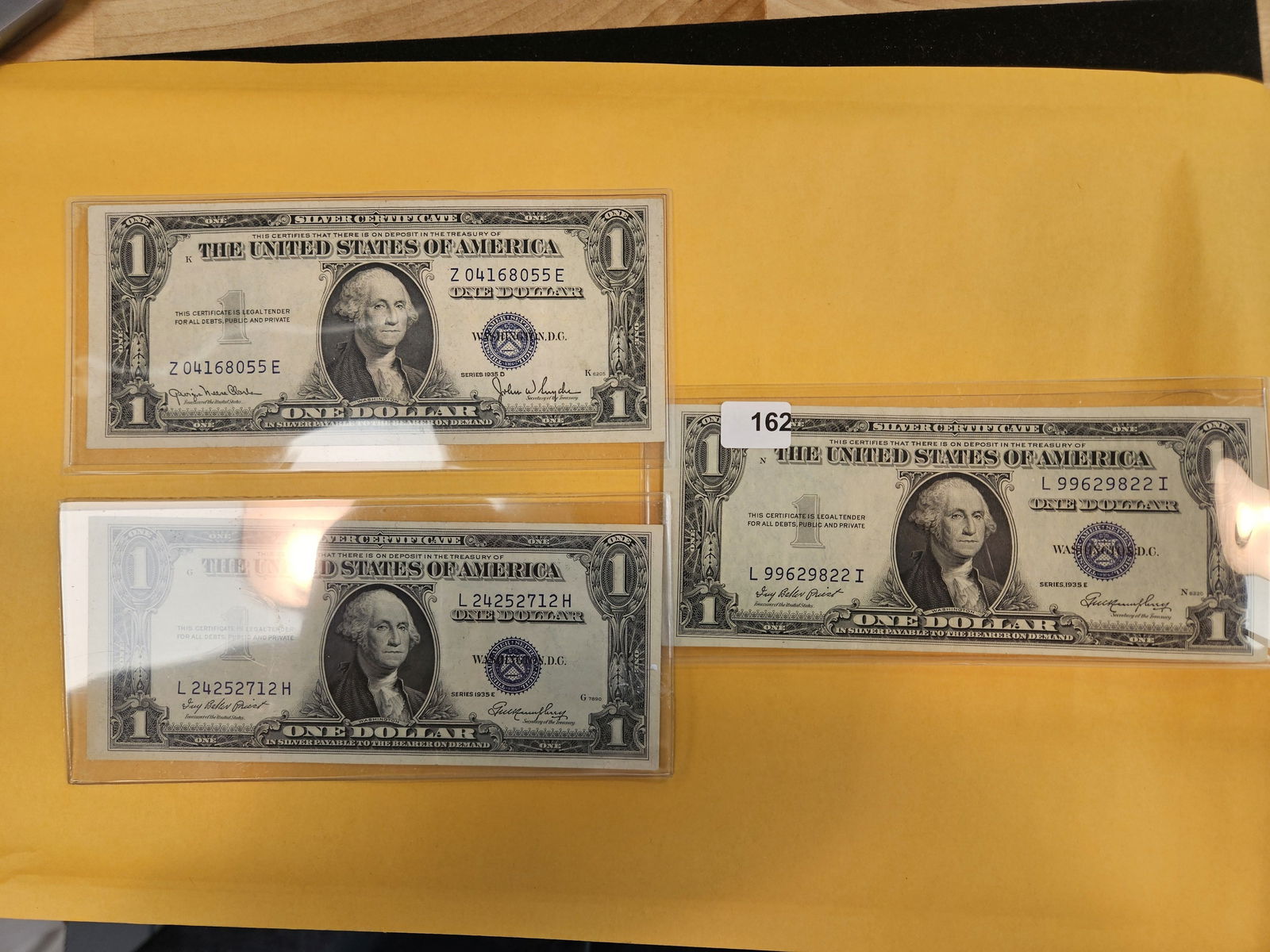 Three 1935-D and 1935-E One Dollar Silver Certificates: Crisp Uncirculated 