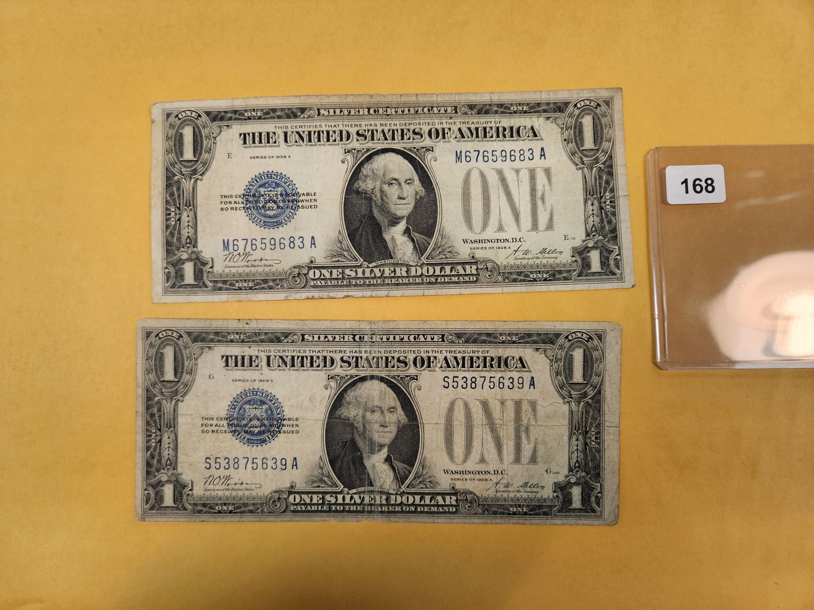 Two Series 1928-A One Dollar Silver Certificates: Both FUNNY BACKS 