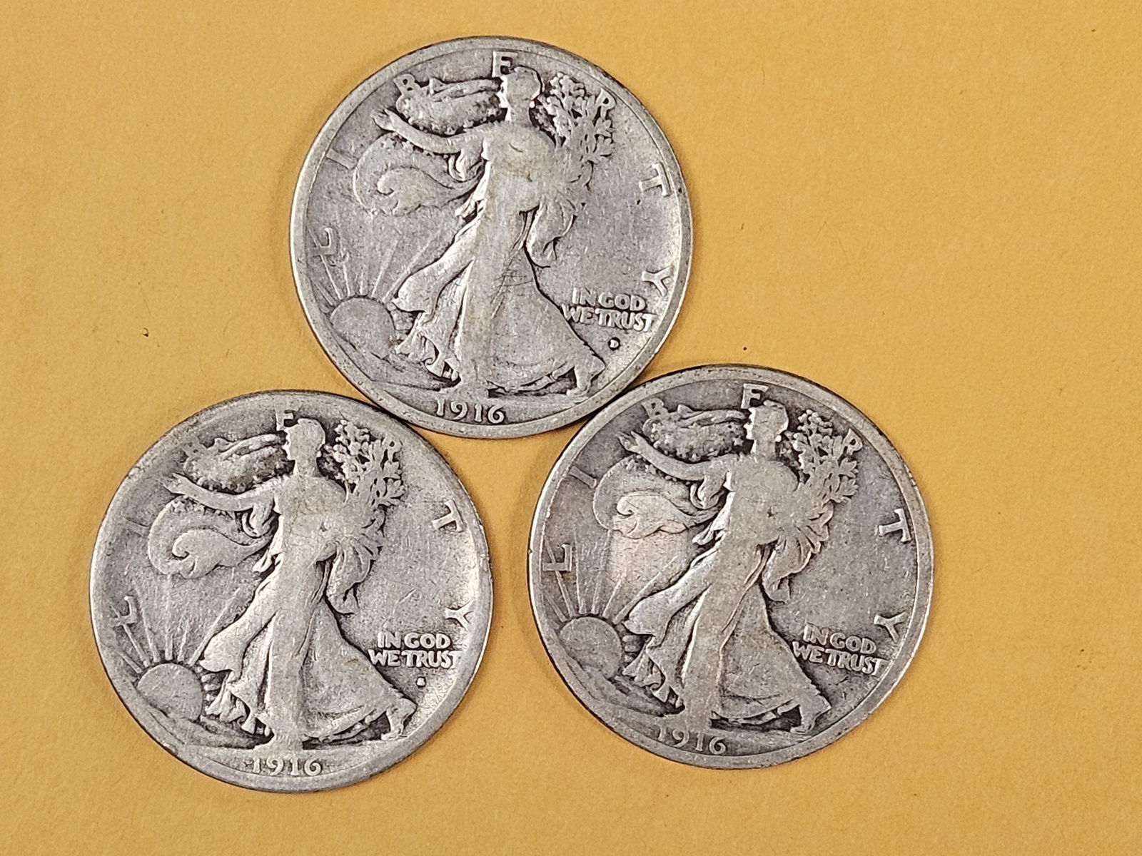 First year Issue Trio of silver Walking Liberty Half Dollars: 1916 P-D-S