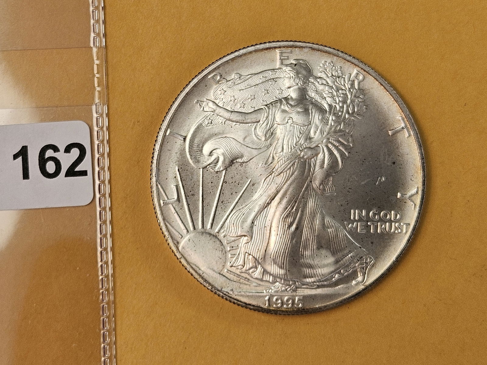GEM Brilliant Uncirculated 1995 American Silver Eagle: Album toning 