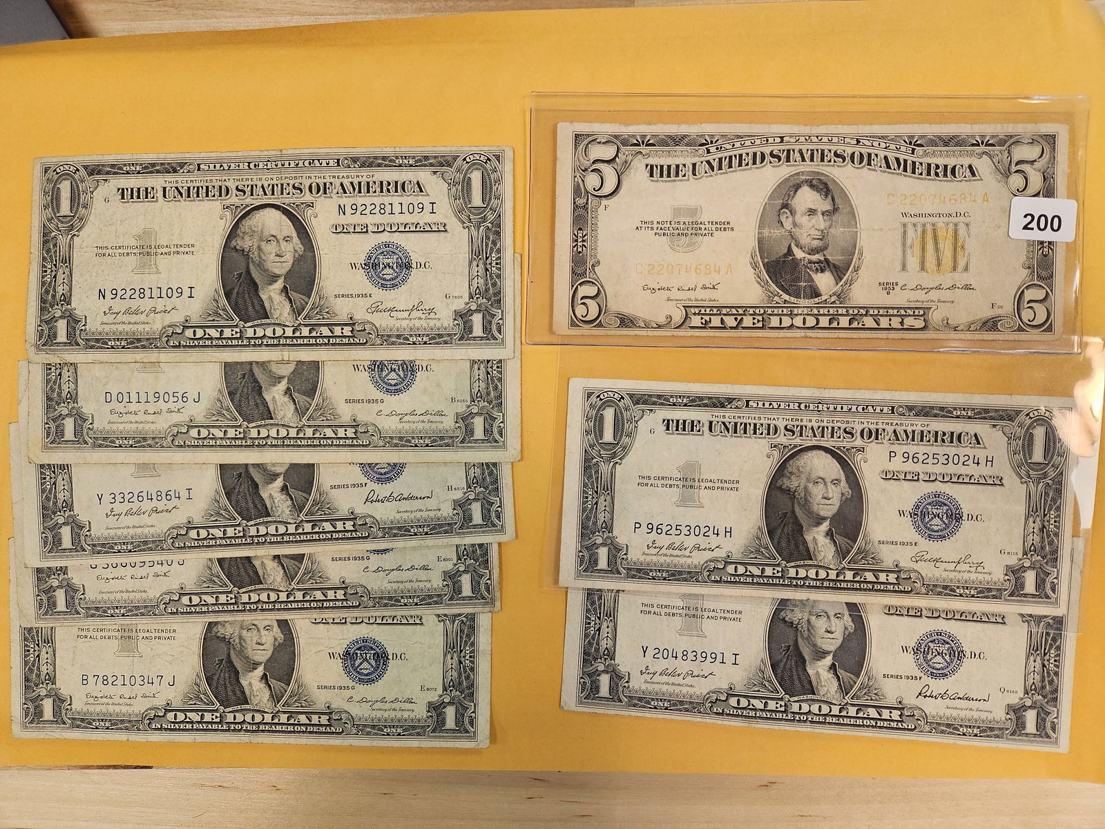 Eight pieces of US Curerncy: Seven $1 Silver Certificates and a Five Dollar US note 