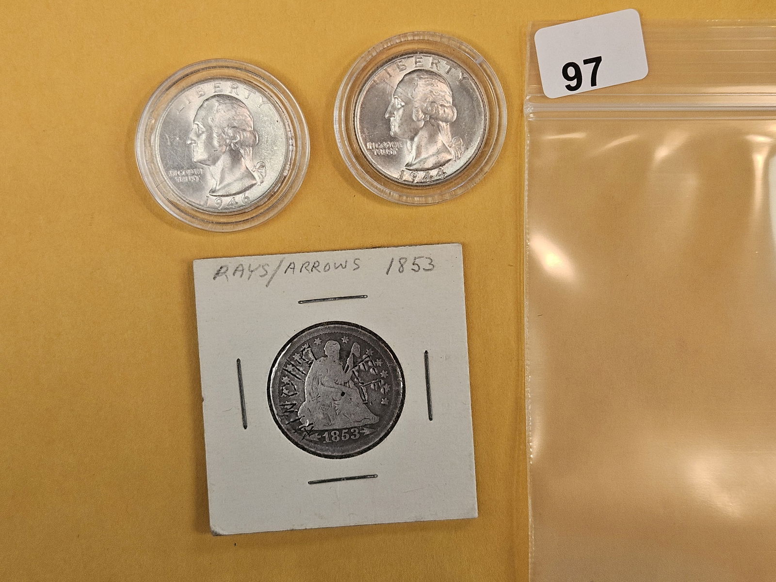 Three mixed silver quarters: Two Choice to Very Choice Brilliant Uncirculated silver Washington Quarters and a Seated Liberty that's had some grafitti carved into it