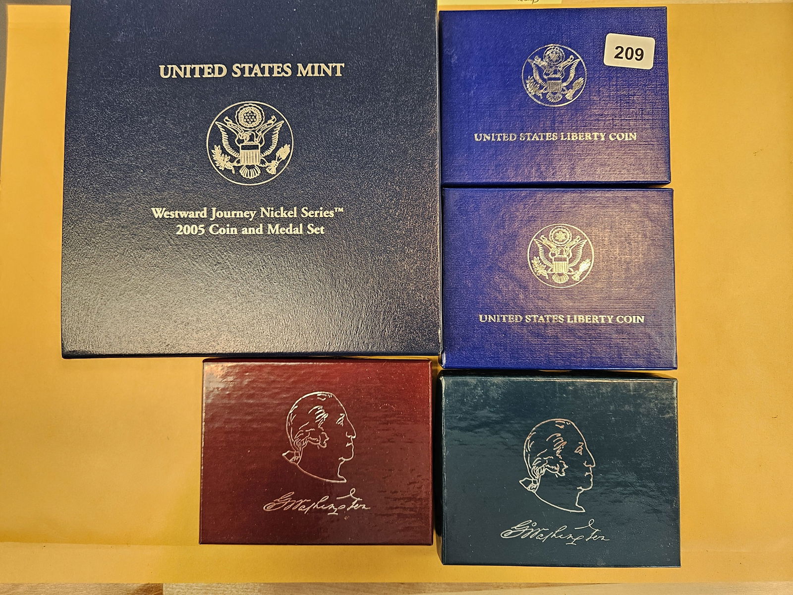Five Mixed US Mint Sets: In OGP. Includes 2 silver half dollars and a commemorative silver dollar 