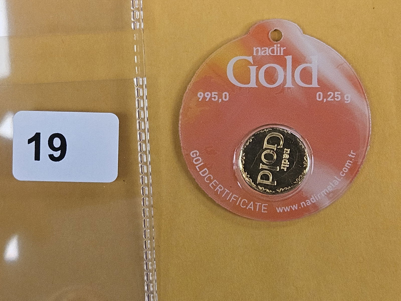 GOLD! NADIR Gold .995 Gold bar in Assay Holder: From Nadir metals. Weighs .25 grams