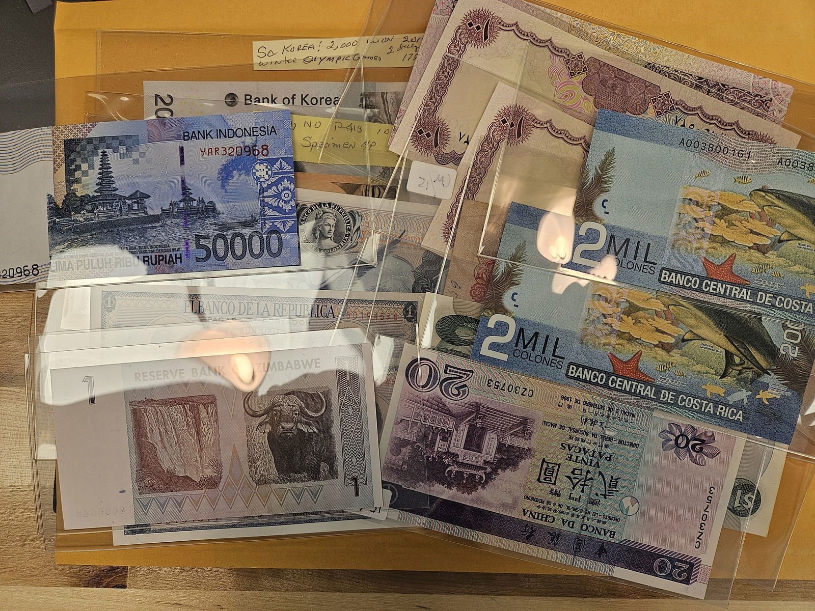 Fifteen Crisp Uncirculated pieces of World Currency: Unchecked by us 
