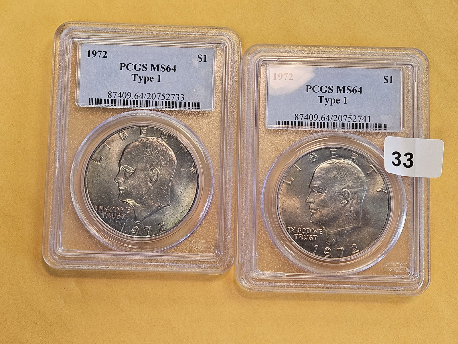 Two, near-gem, PCGS-grade 1972 Eisenhower Dollars: Both in Mint State 64. Both Type 1. Both with a light patina 