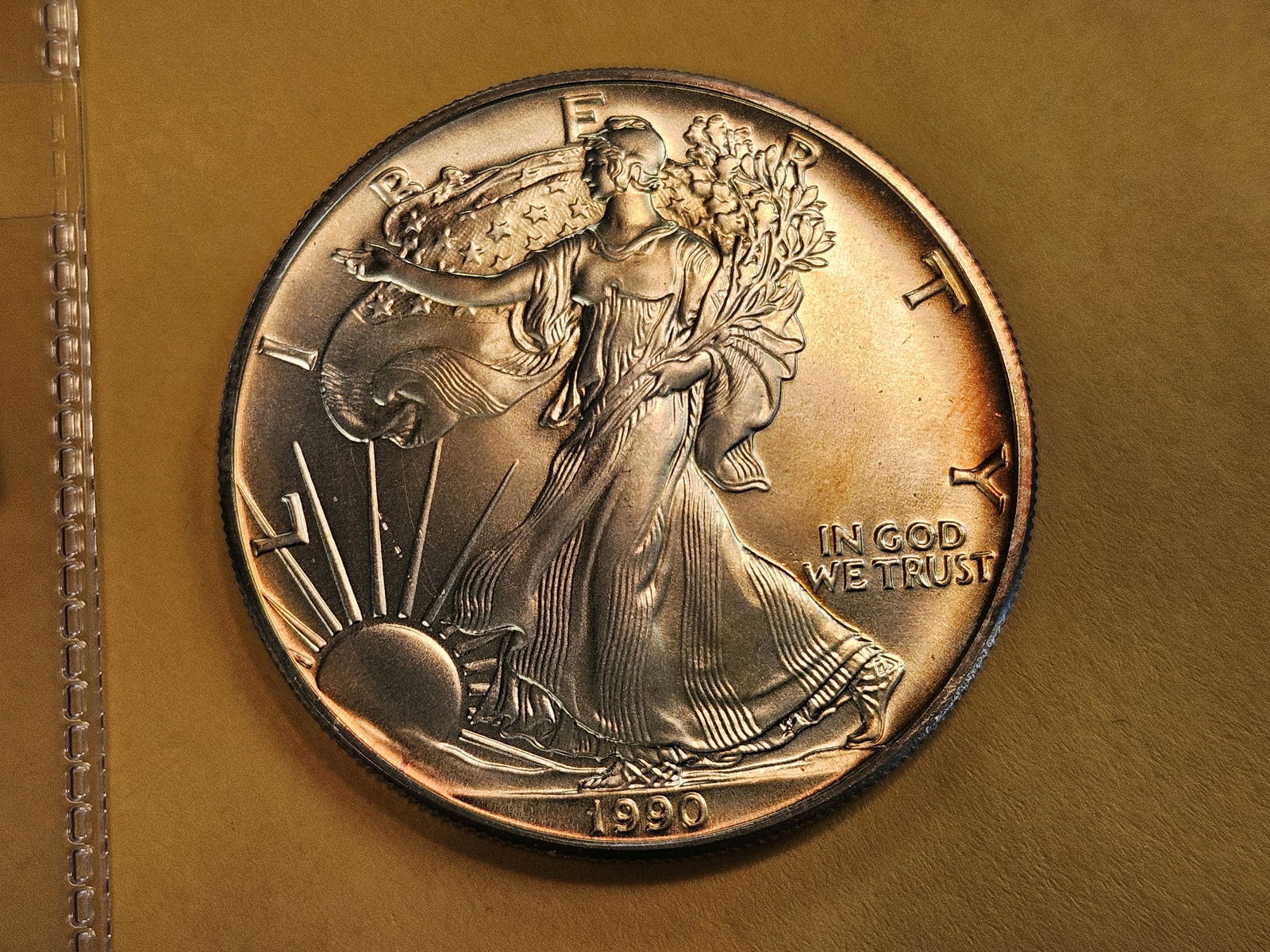 GEM Brilliant Uncirculated 1990 American Silver Eagle: Album toning 