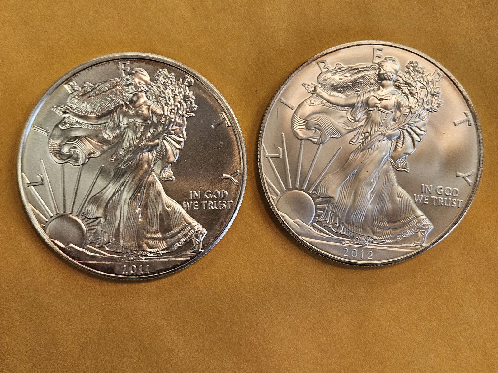 Two GEM Brilliant Uncirculated American silver Eagles: 2011 and 2012 