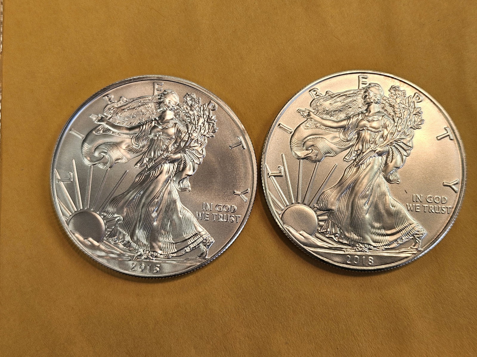 Two GEM Brilliant Uncirculated American silver Eagles: 2015 and 2018 