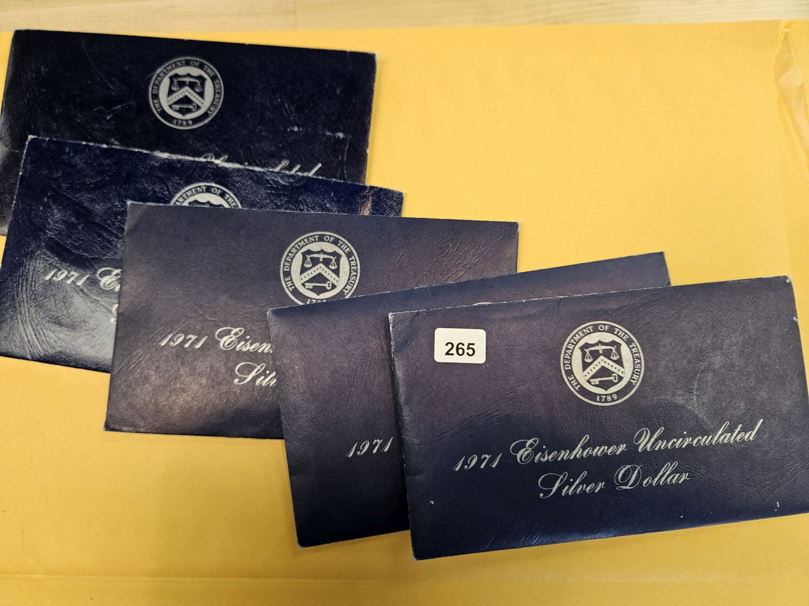 Five GEM Brilliant Uncirculated SILVER Blue Ikes: Silver Eisenhower Dollars in Blue envelopes. In original blister packs 
