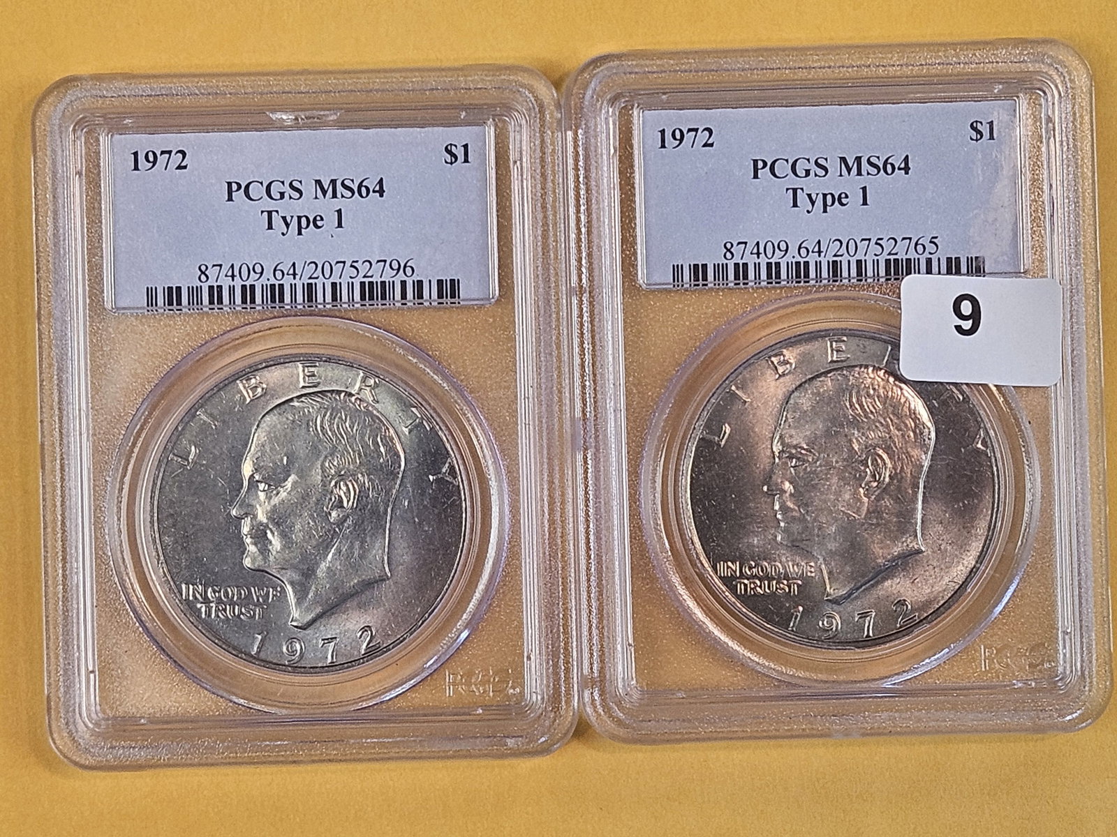 Two PCGS-graded Eisenhower Dollars in Mint State 64: Both lightly toned. Both 1972 Type 1 