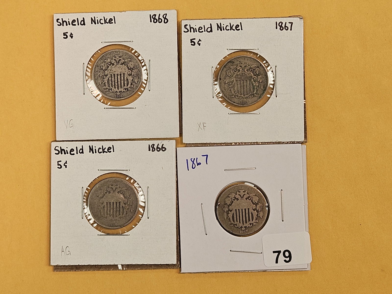 Four mixed Shield Nickels: 1868, 1867, 1866 and 1867 