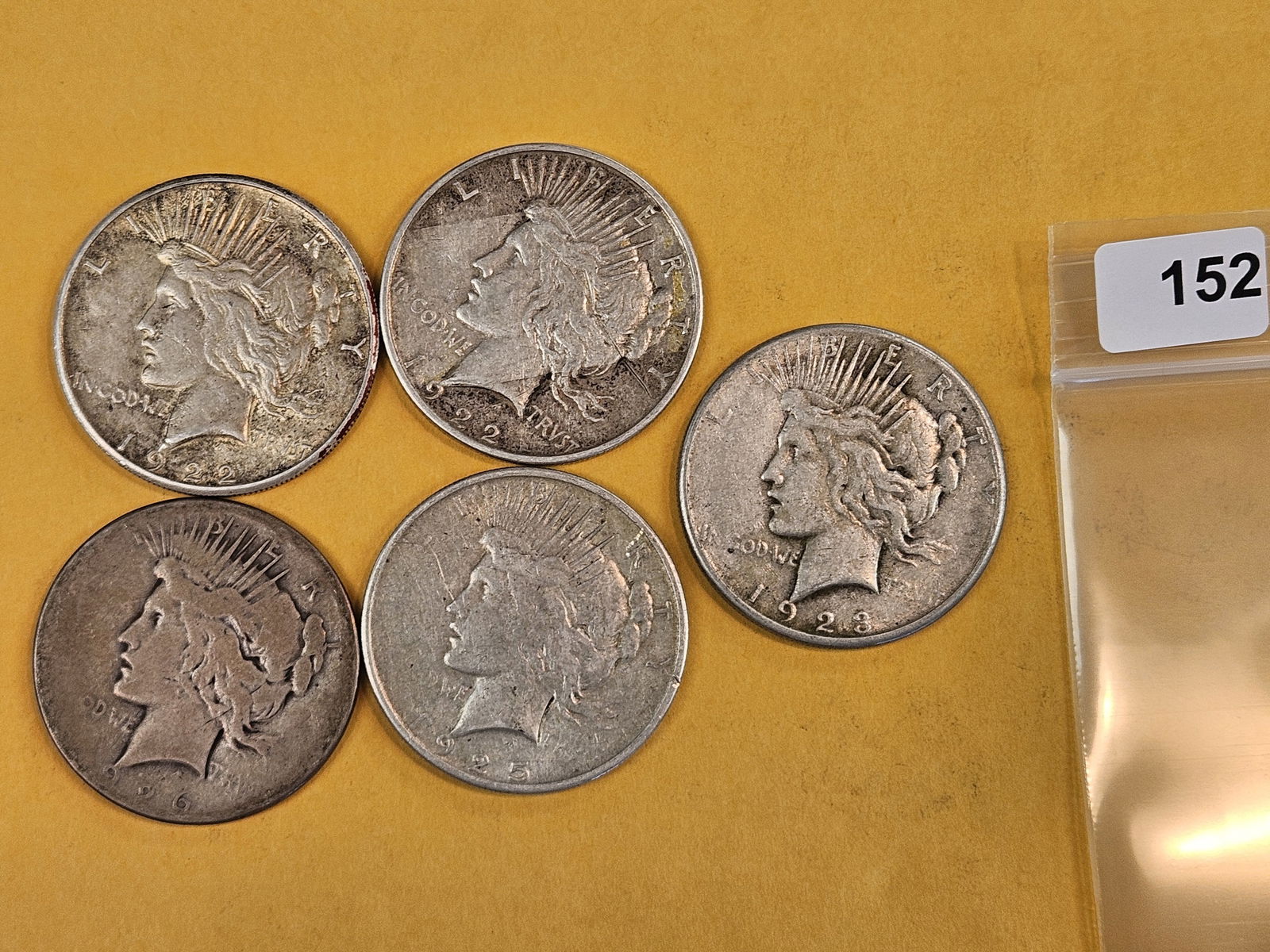 Five mixed Peace Silver Dollars: Circulated 
