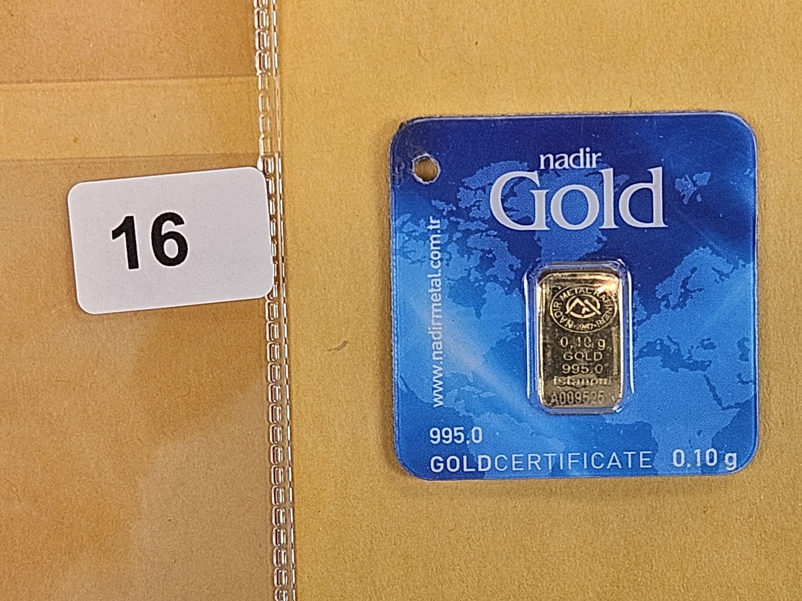 GOLD! NADIR Gold .995 Gold bar: In original assay certification holder. Weighs .1 grams