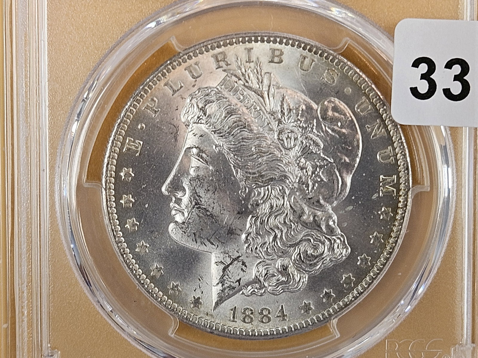 PCGS 1884-O Morgan Dollar in Mint State 63: Bright! 