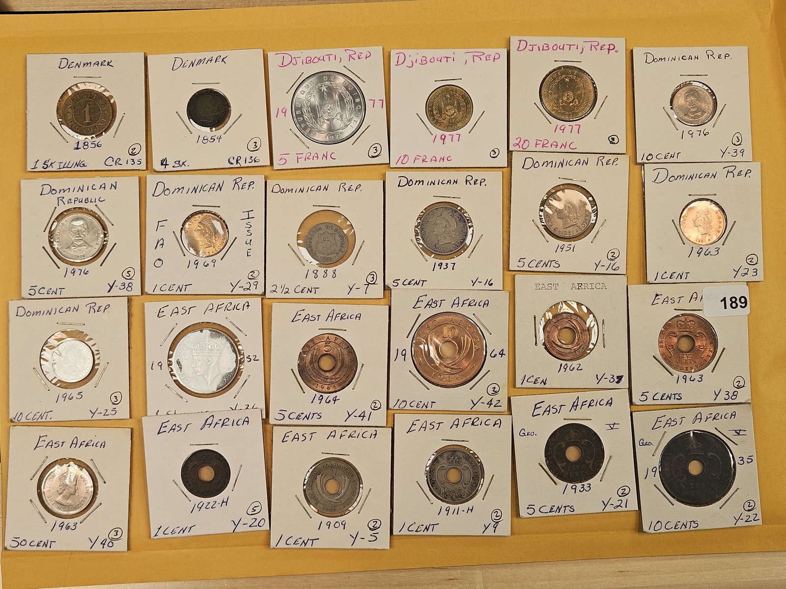Twenty-four mixed World coins: All identified by date, denomination and KM number. All in 2x2's 