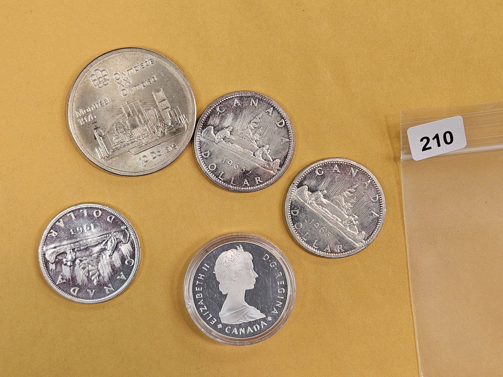 Five larger, Canadian, silver coins: Dollars and 10 dollars