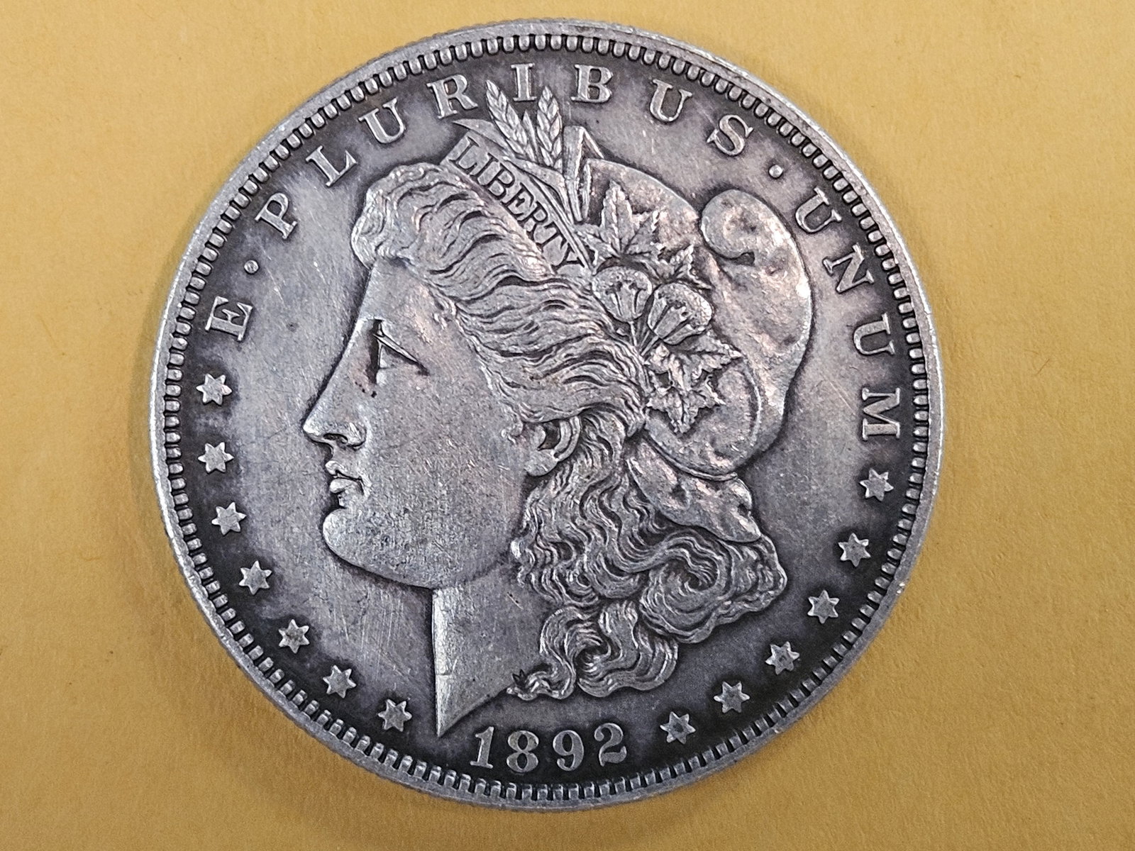 Better Grade 1892 Morgan silver Dollar in About Uncirculated - 58: Good looking patina! 