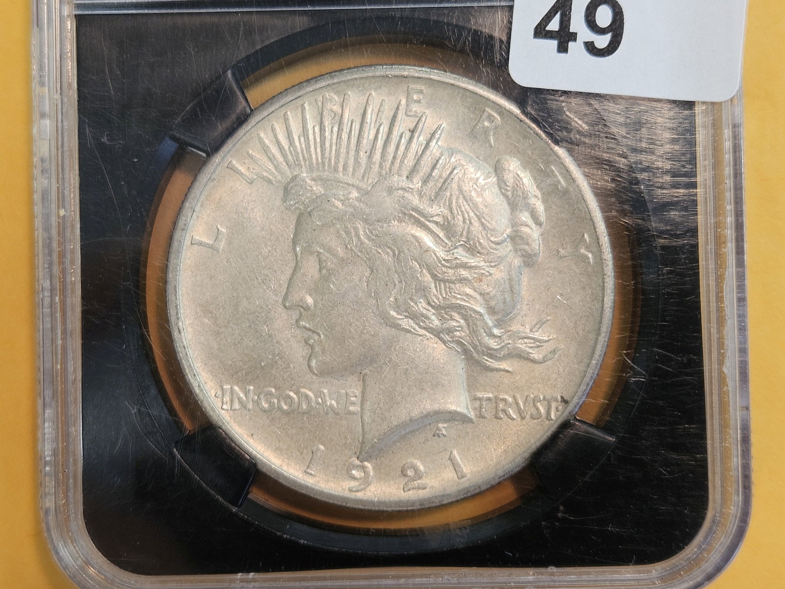 ** KEY DATE! NGC 1921 Peace Silver Dollar in About Uncirculated - 58: KEY DATE! First Year Issue. High relief. In scarcer NGC Black Holder! 