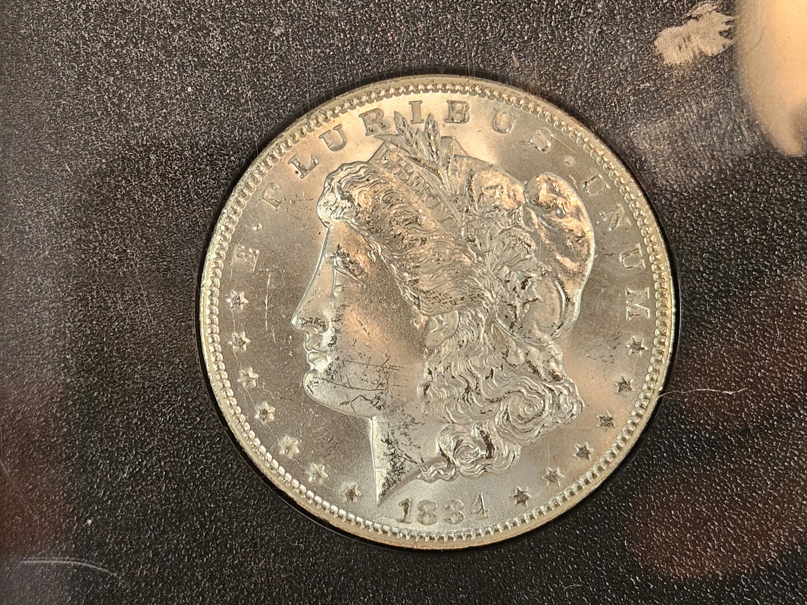 ** KEY DATE ** CACG 1884-CC Morgan Dollar in Mint State 64: KEY DATE! CARSON CITY! Graded by CAC! Tough grading standards. This beauty is purt near GEM! White and frosty with very clean fields and just a little bit of toning! 