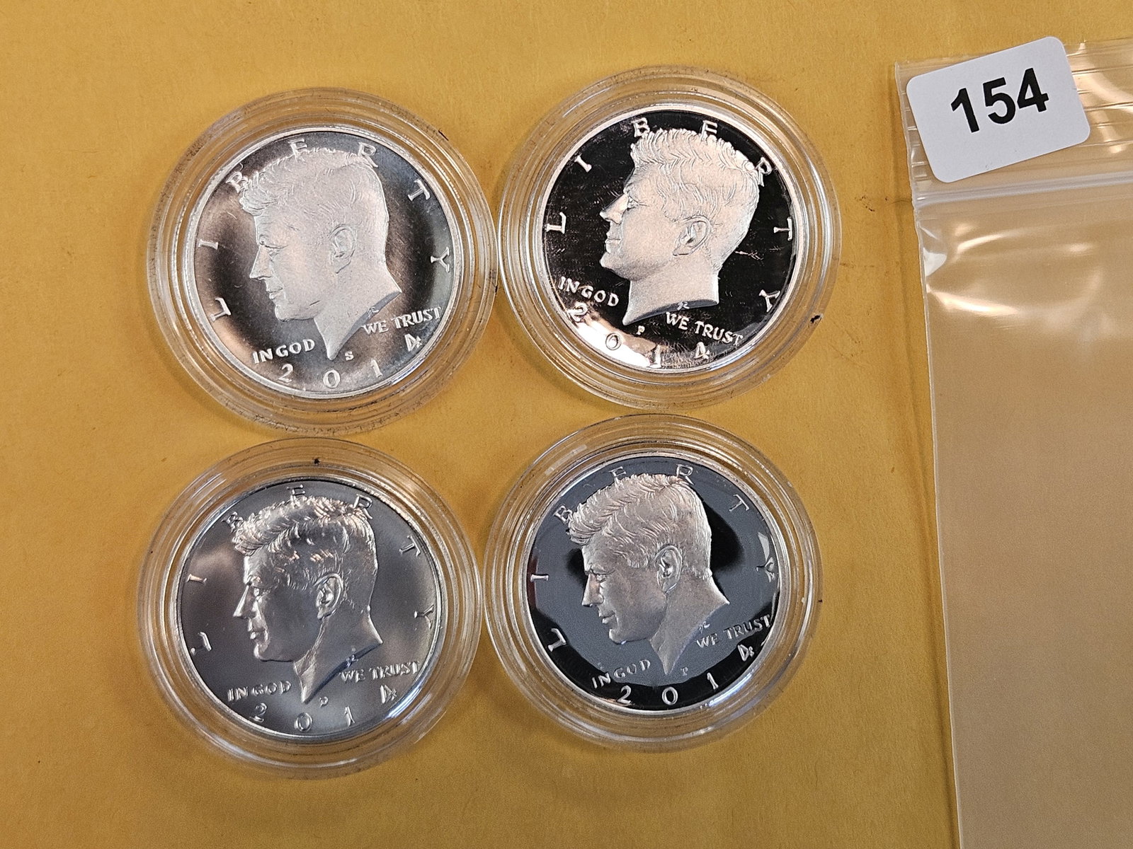 Four GEM Silver Kennedy Half Dollars in original plastic capsules (1 of 4)
