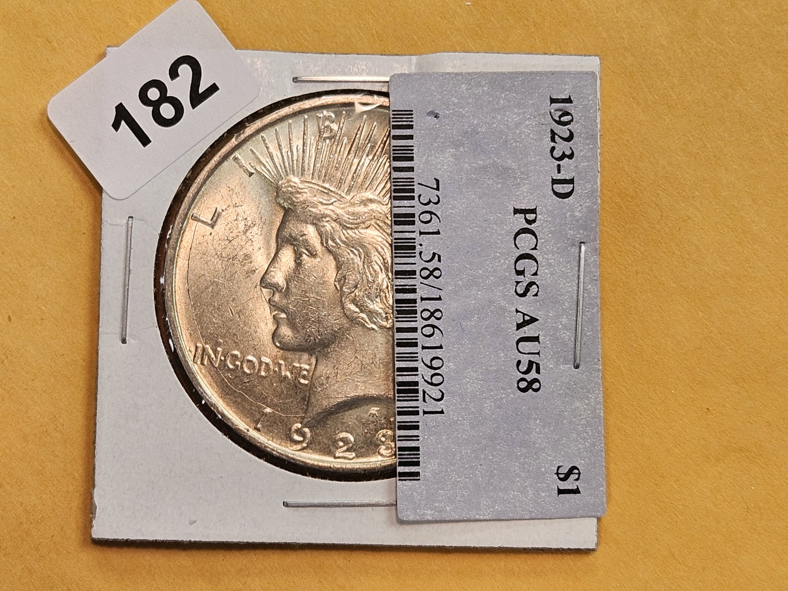 Choice Brilliant About Uncirculated Plus 1923-D Peace Silver Dollar: This beauty was originally housed in a PCGS holder and graded AU-58. The collector took a lot of his coins and took them out of the slabs and put them in Dansco albums. 