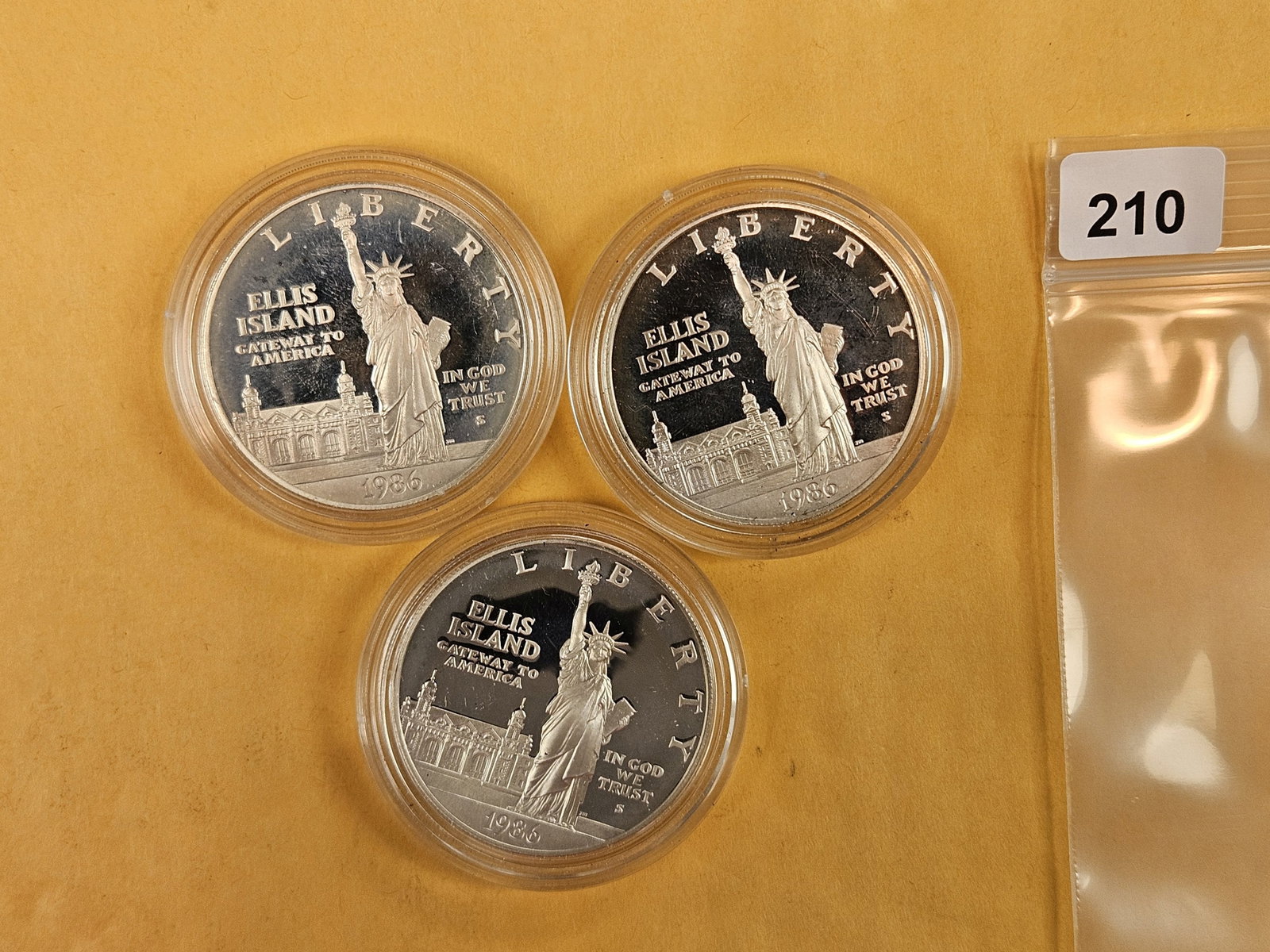 Three 1986 Commemorative Proof Silver Dollars: In original plastic capsules