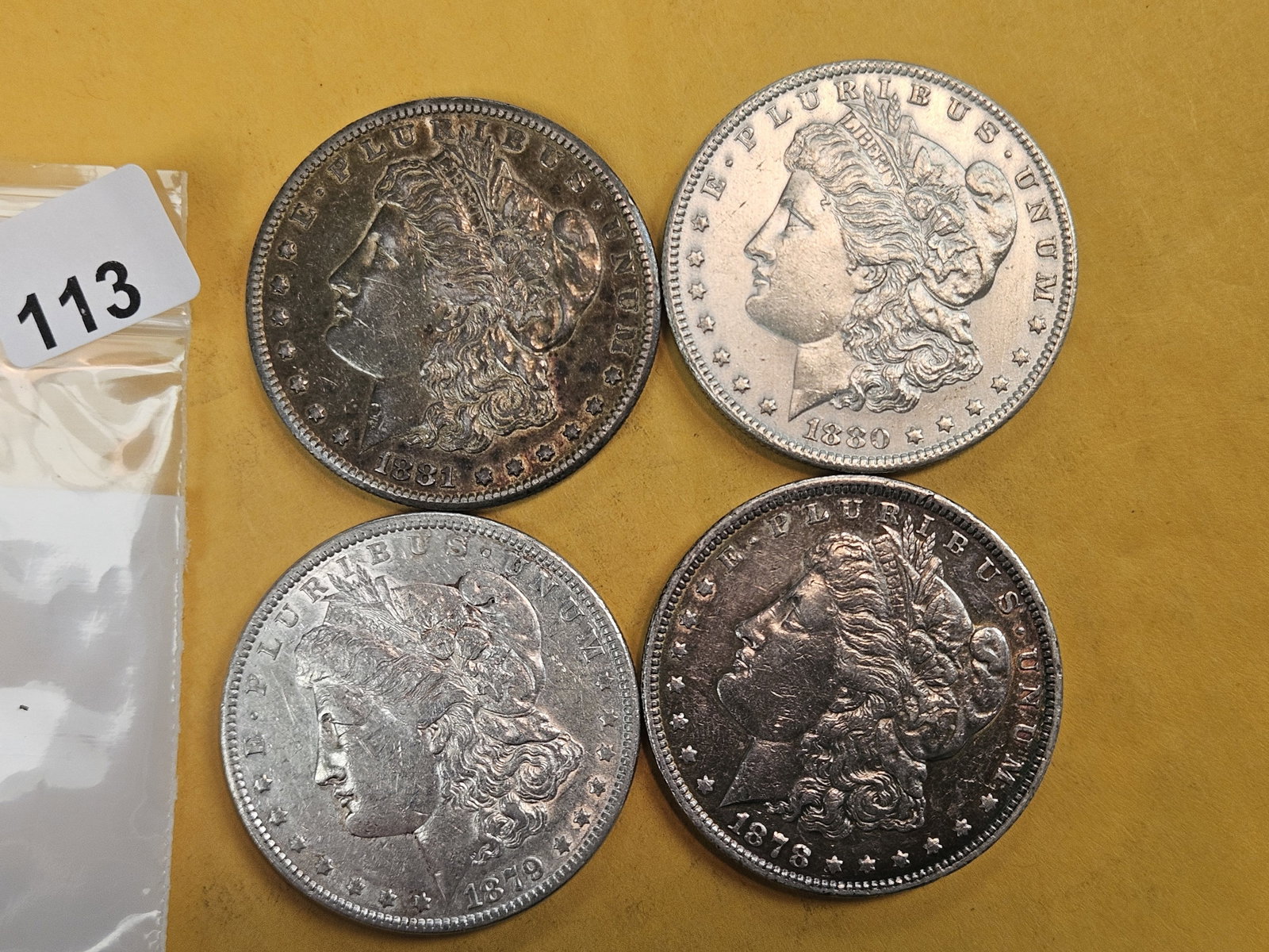 Four About Uncirculated Morgan silver Dollars: Mixed