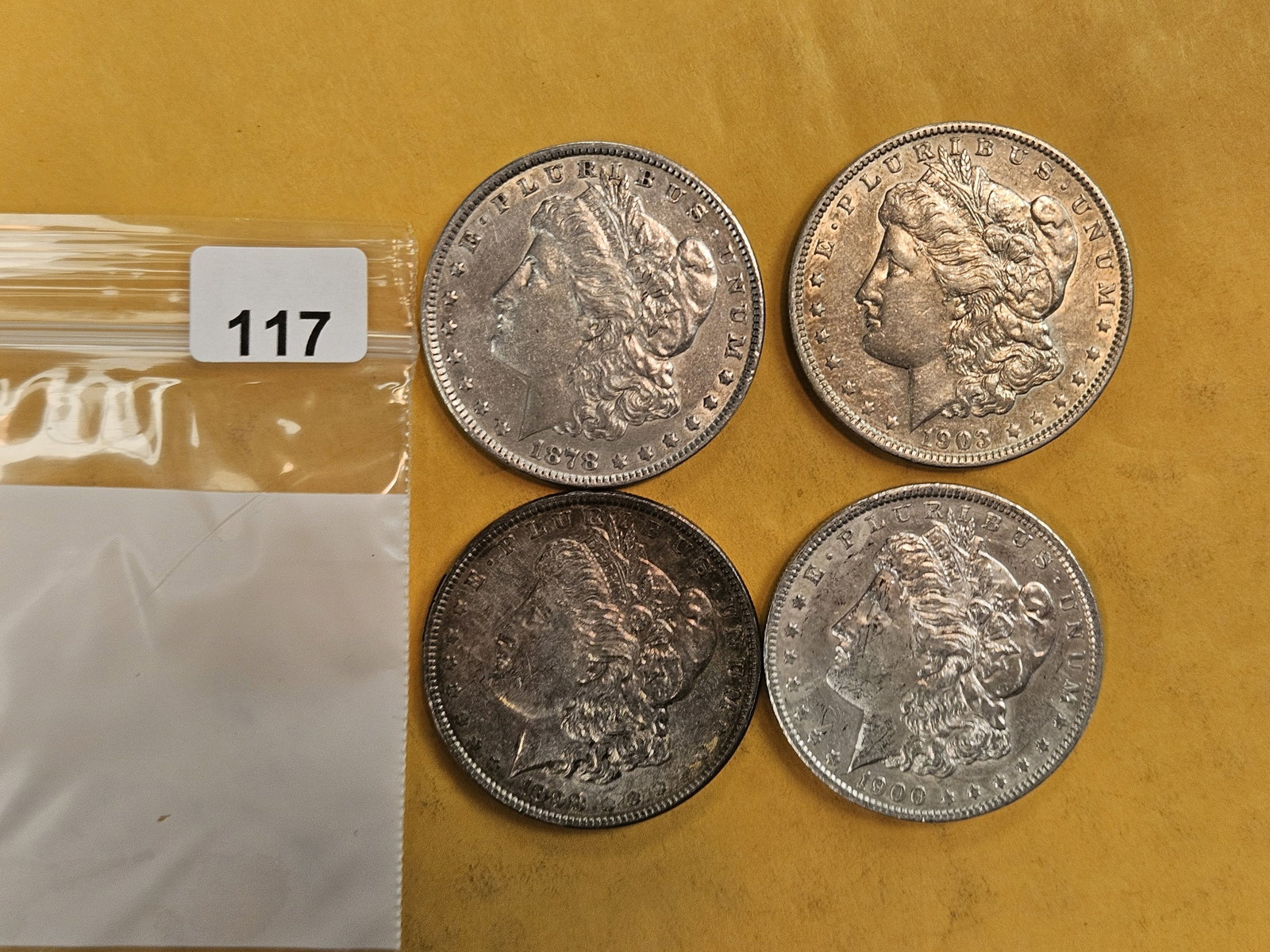 Four About Uncirculated Morgan silver Dollars: Mixed