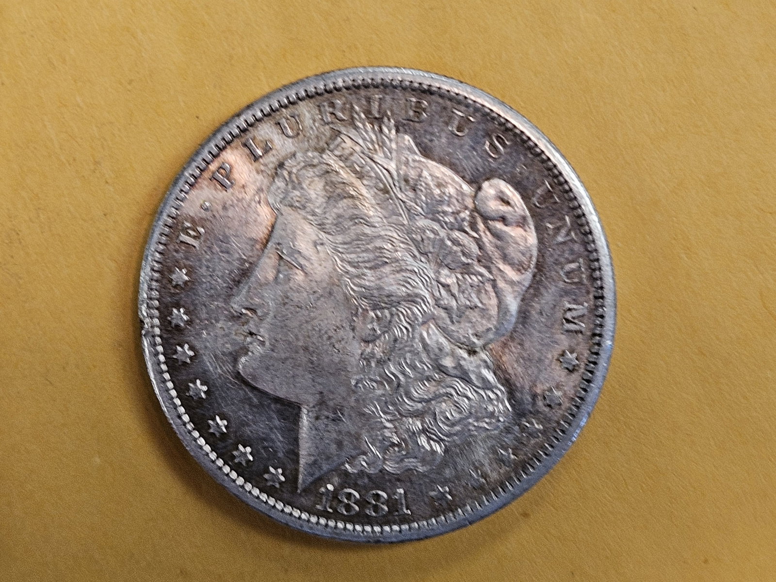 Brilliant Uncirculated plus 1881-S Morgan silver Dollar: Light patina