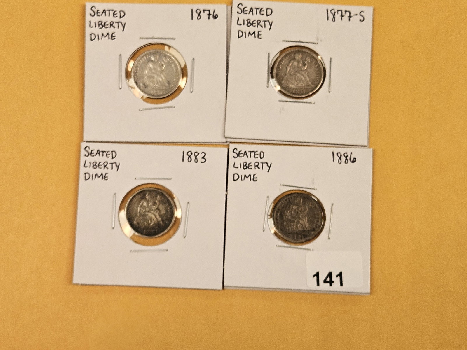 Four Seated Liberty silver dimes in Very Fine to Extra Fine: 1876, 1877-S, 1883 and 1886