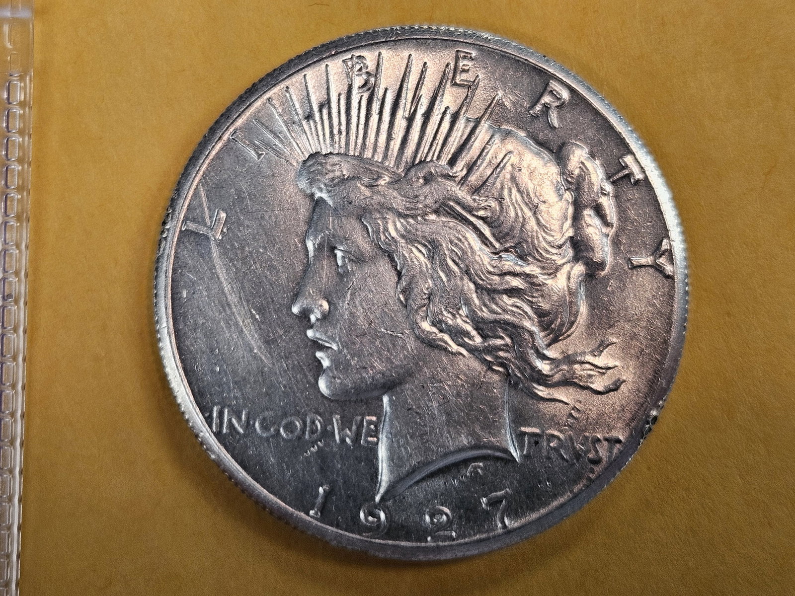 Brilliant About Uncirculated plus 1927 Peace Silver Dollar: Good luster