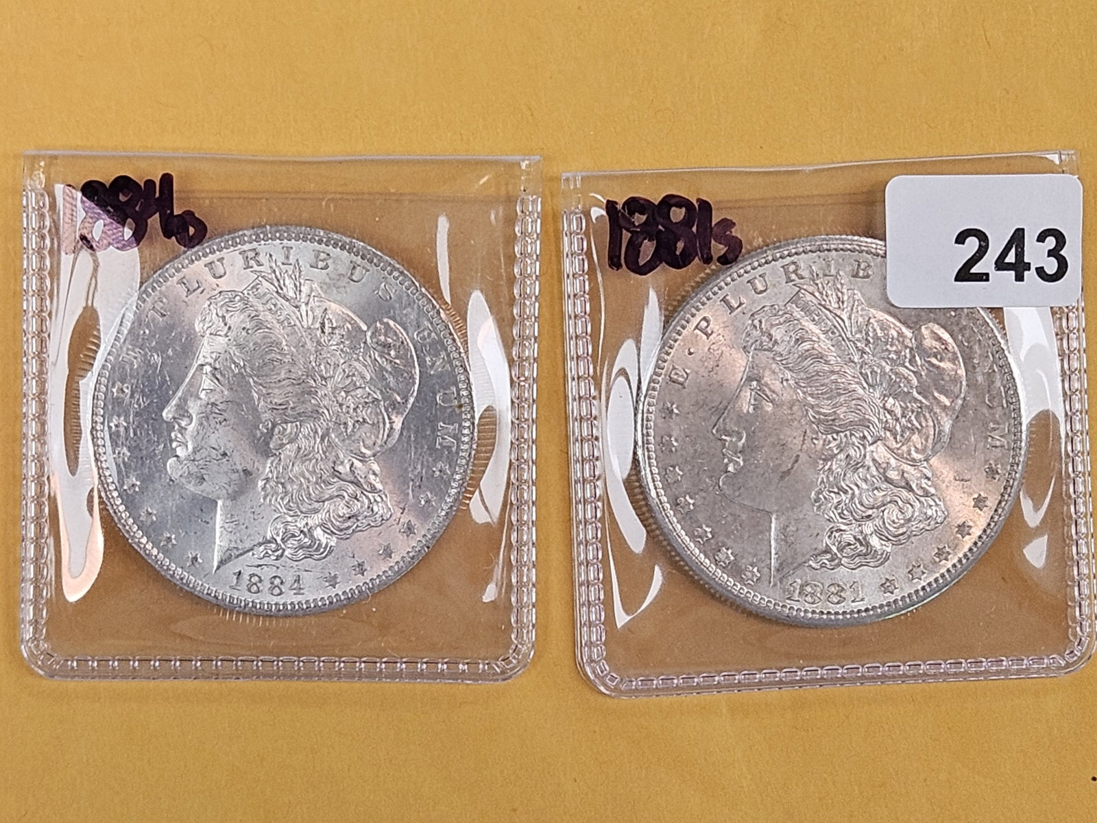 Two Brilliant Uncirculated Morgan Silver Dollars: 1884-O and 1881-S
