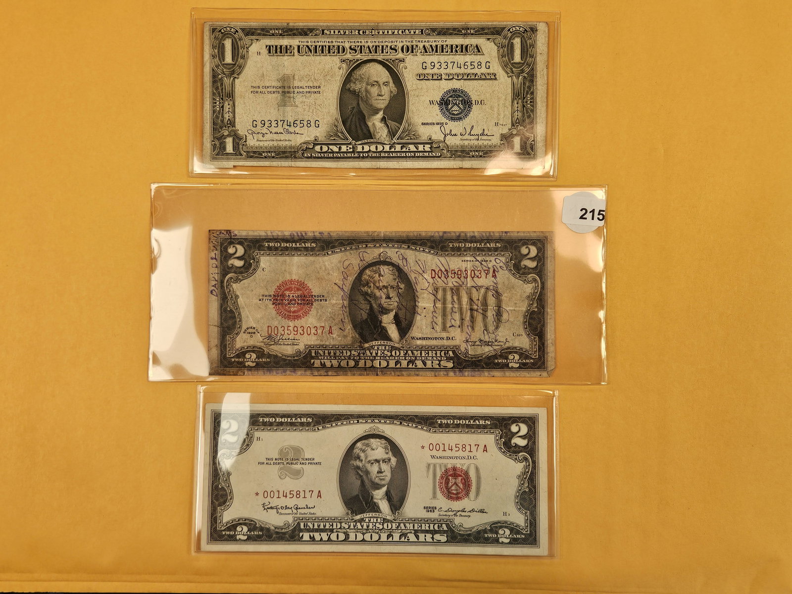 Three mixed different pieces of US Currency: 1935-D $1 Silver Cert, Two Dollar Short Snorter and 1963 Crisp $2 STAR