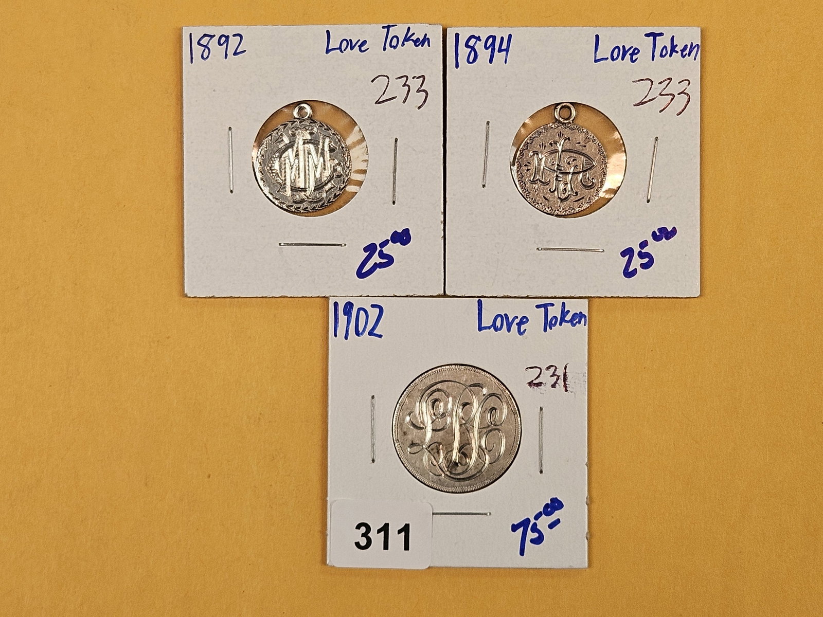 Three cool, silver, Love Tokens: Two made out of dimes and one made from a quarter