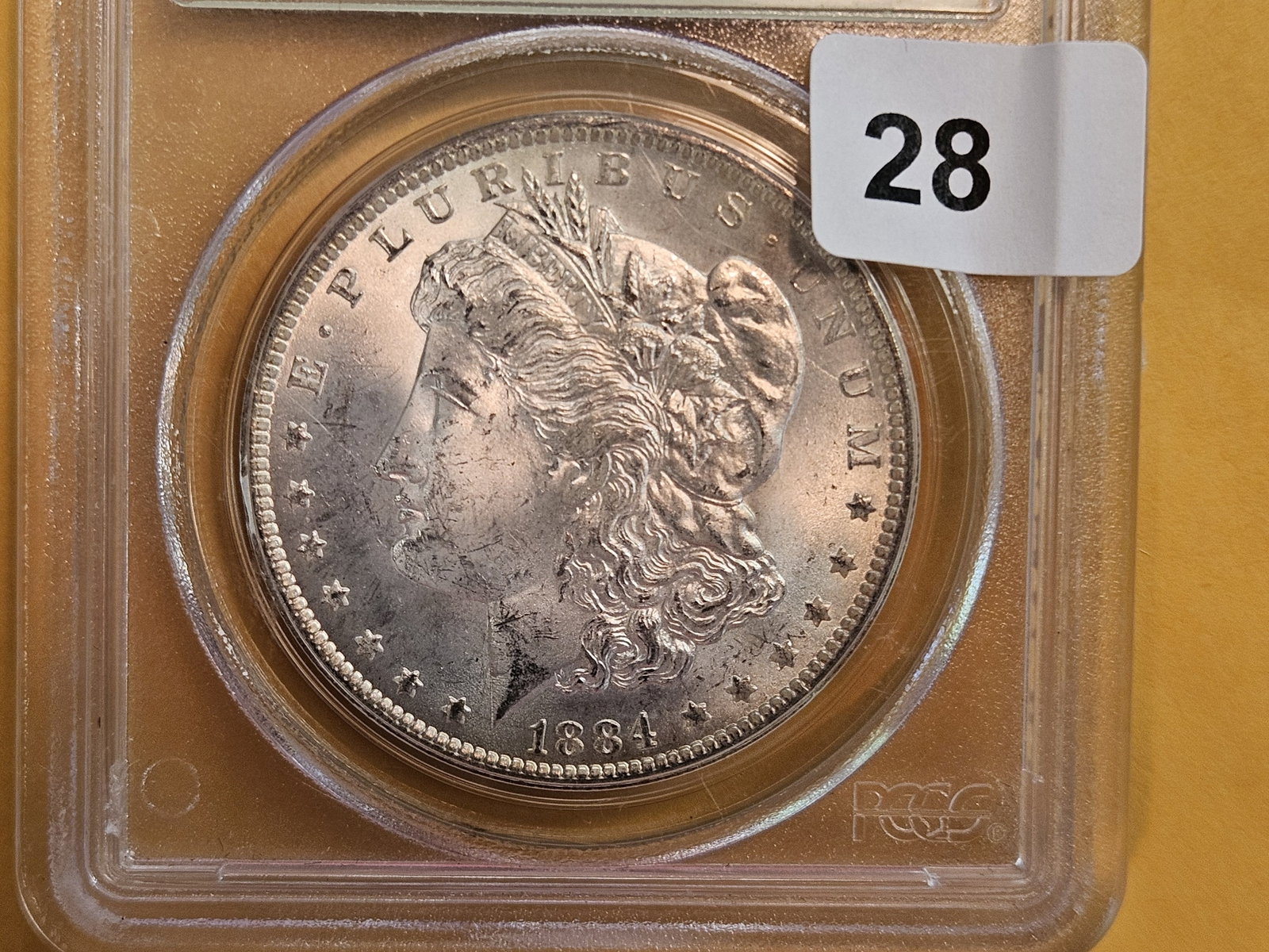 OGH! PCGS 1884-O Morgan Dollar in Mint State 63: Old Green Holder. Reverse is starting to tone