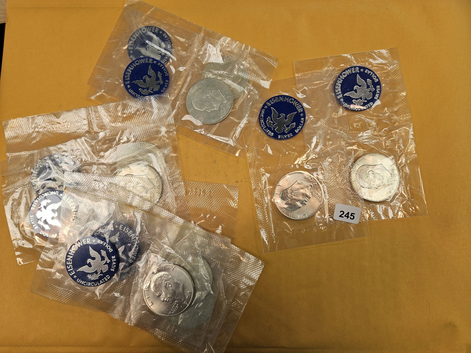 Ten GEM Brilliant Uncirculated SILVER Blue Ike Dollars: Silver Eisenhower Dollars. All in original blister packs