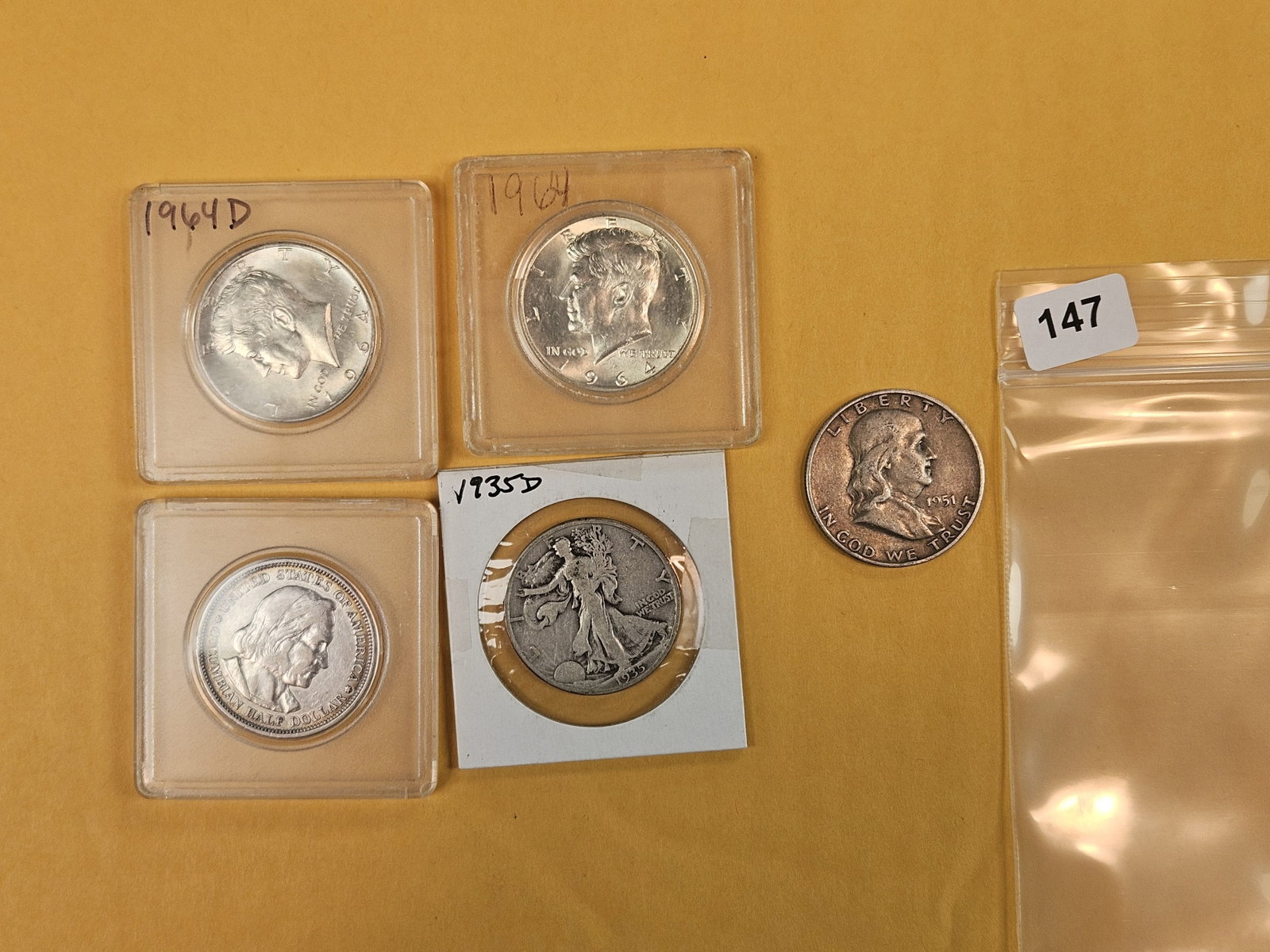 Five mixed design silver half dollars: Kennedy, Walking, Franklin
