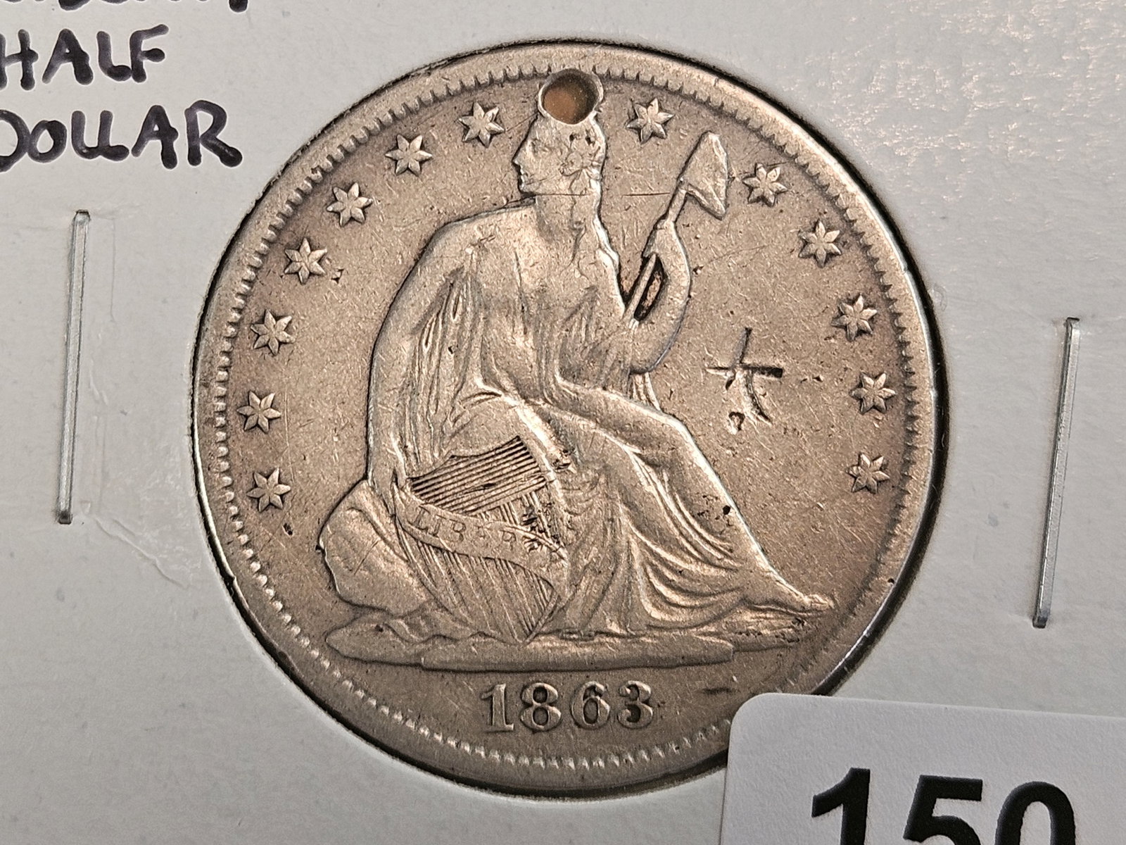 * Unique*?? Civil War Issue Seated Liberty silver Half Dollar: 1863-S. Has a Chopmark on it, just one. And is holed for suspension. Not sure I've ever seen one quite like this. Pretty cool