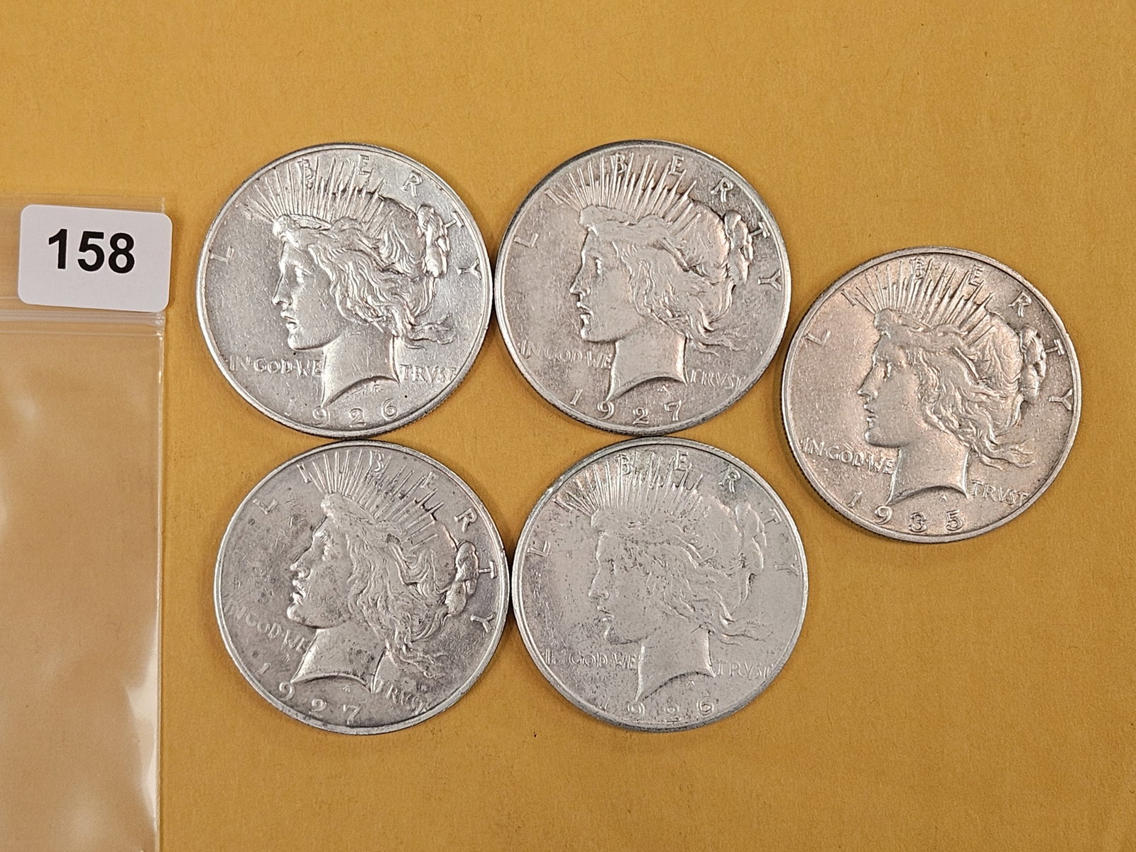 Five mixed silver Peace Dollars (1 of 3)