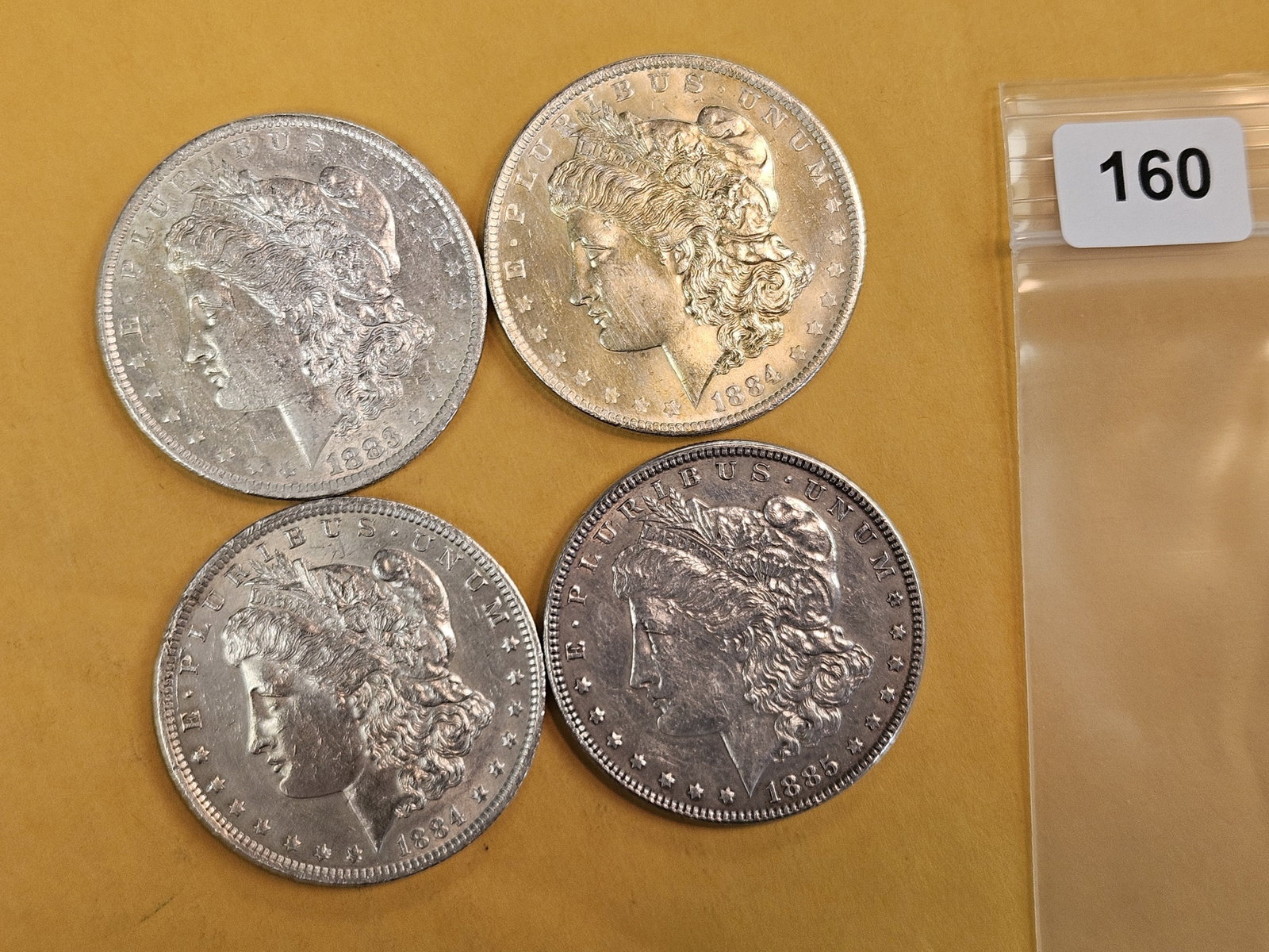 Four About Uncirculated Morgan Silver Dollars: Mixed