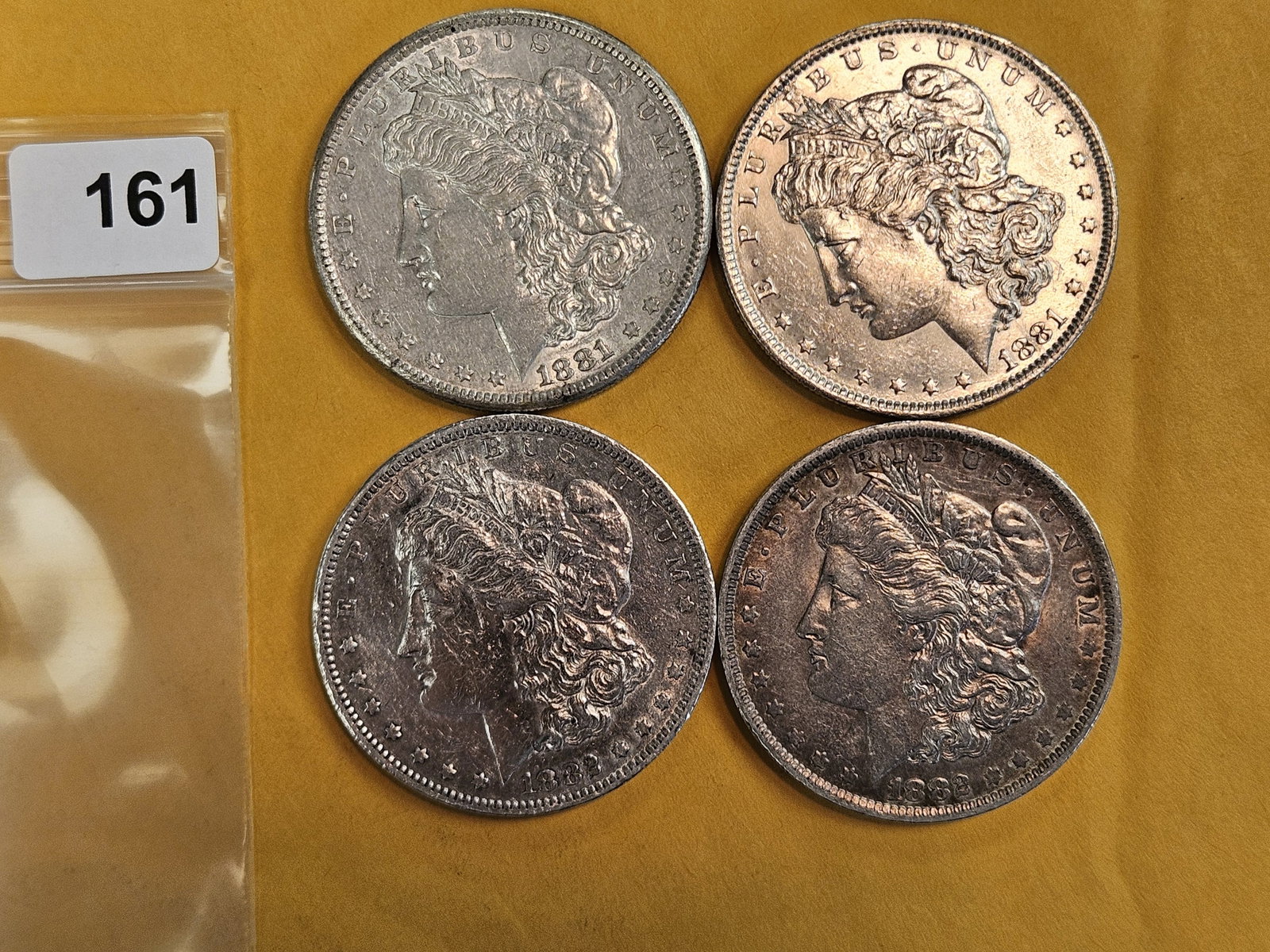 Four About Uncirculated Morgan Silver Dollars: Mixed