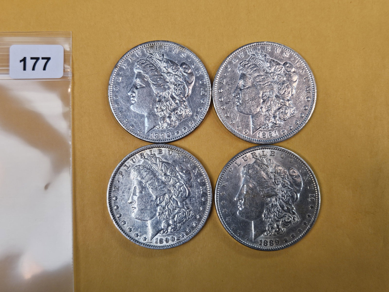Four mixed About Uncirculated Morgan Silver Dollars: Mixed