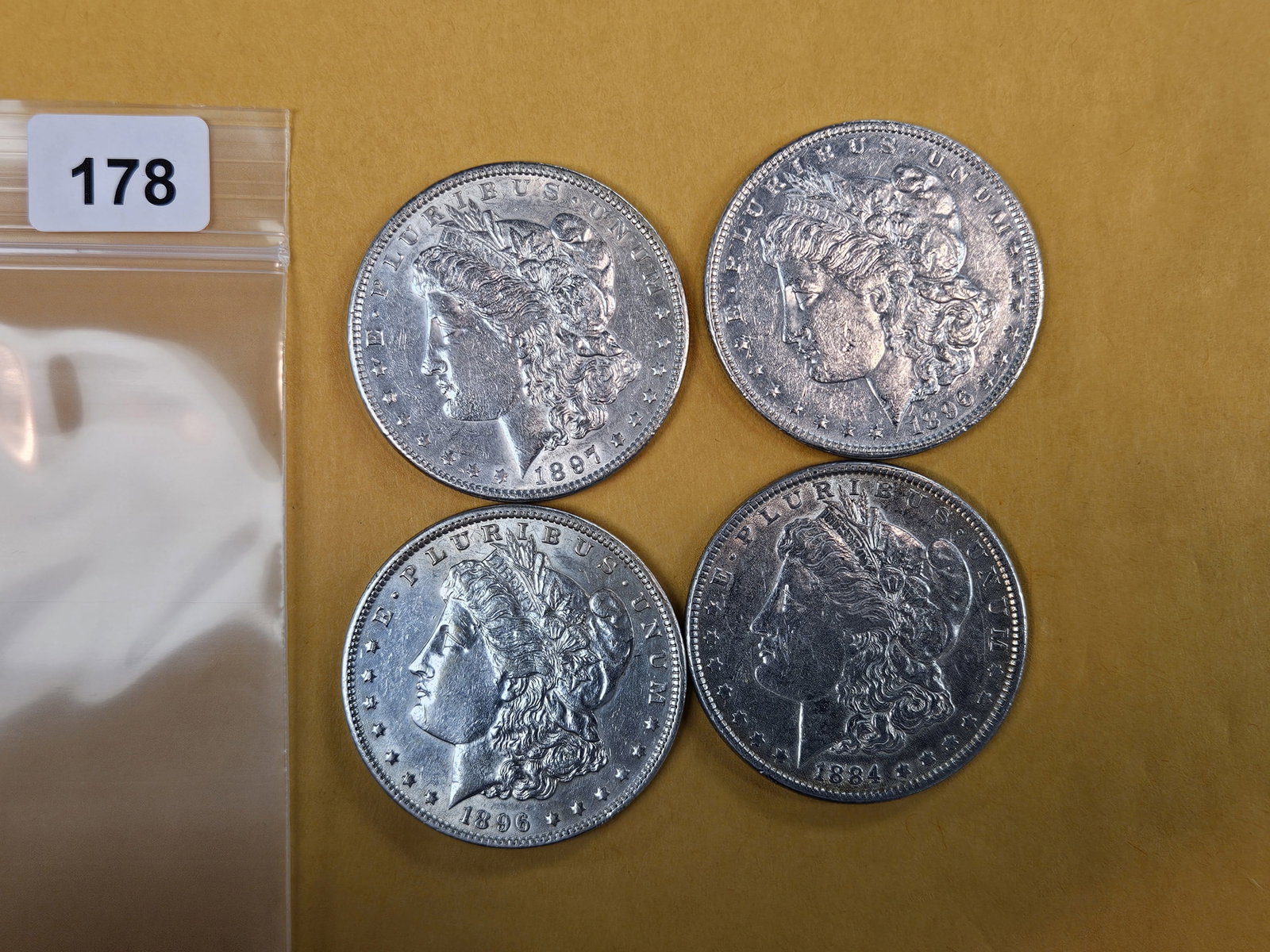 Four mixed About Uncirculated Morgan Silver Dollars: Mixed