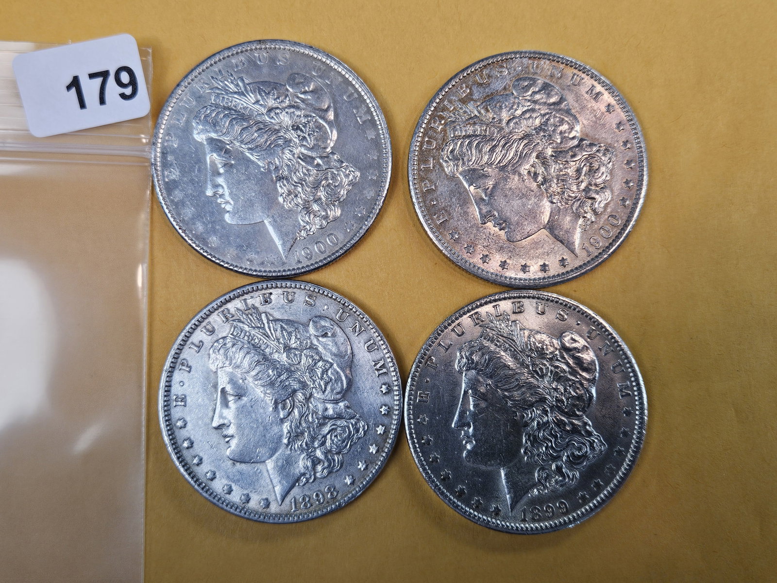 Four mixed About Uncirculated Morgan Silver Dollars: Mixed